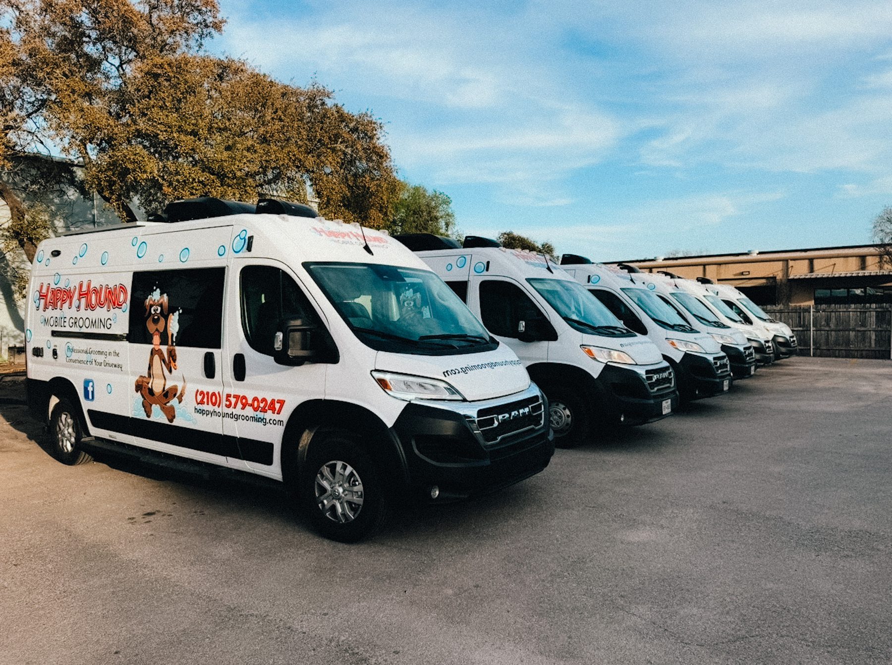 The Happy Hound Mobile Grooming fleet of vans lined up